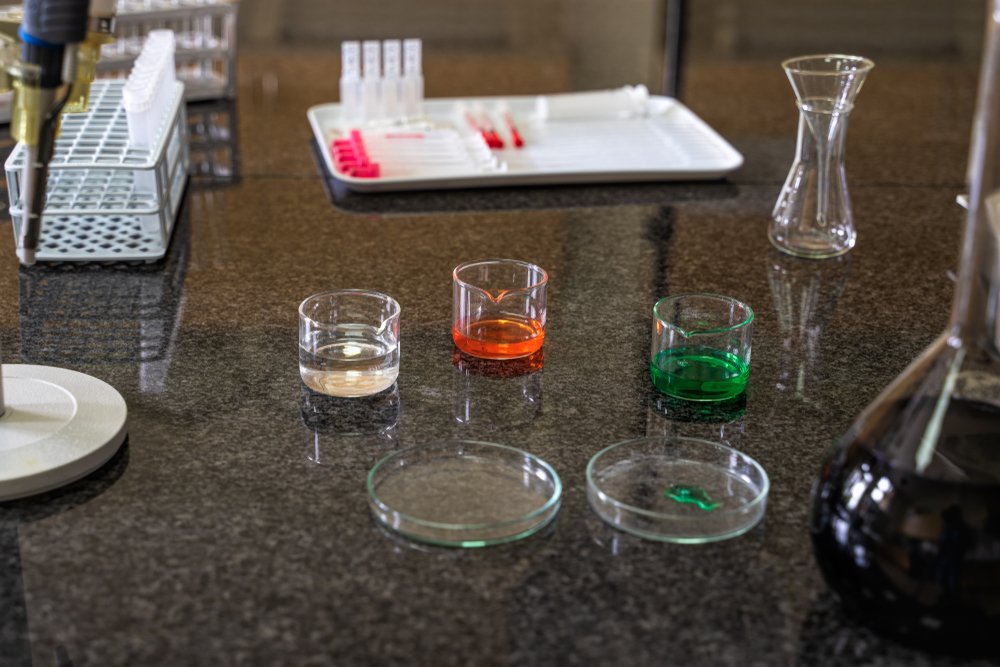 Chemical liquid solutions in flasks on laboratory worktop