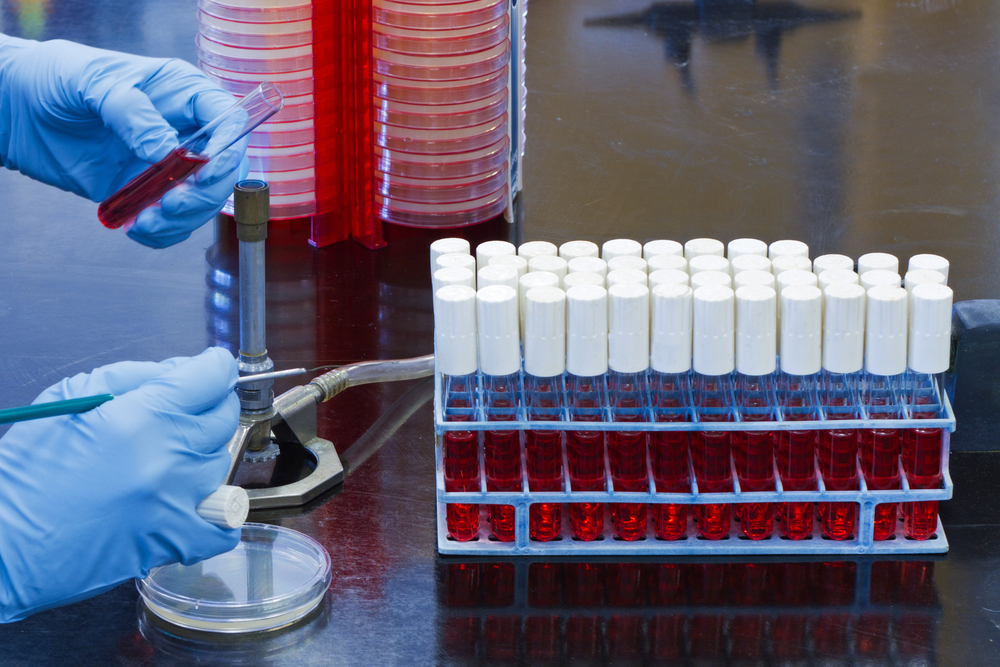 Flaming a tube on chemical-resistant surface in microbiology laboratory