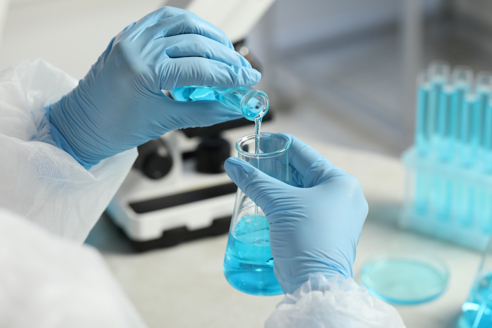  Scientist working with flasks in laboratory