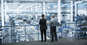 Engineer and Scientist overlooking multi-disciplinary research facility