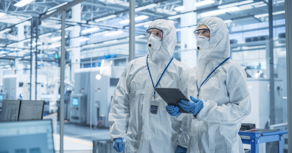 Industrial Scientists Wearing Disposable Protective Suits