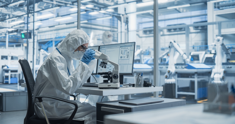 Laboratory seating - Cleanroom Scientist Using a Microscope