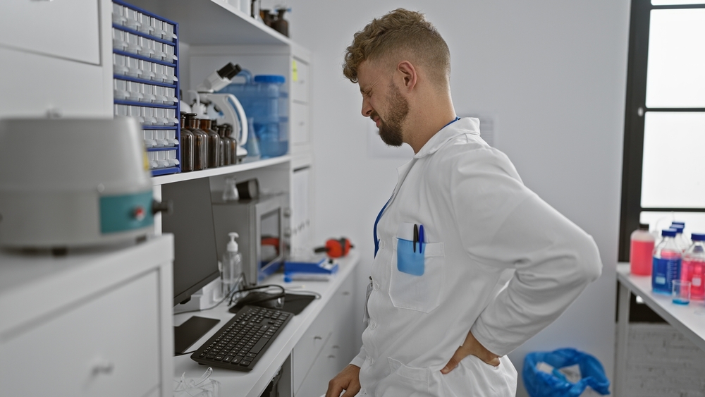  Scientist with back pain in a clinical laboratory