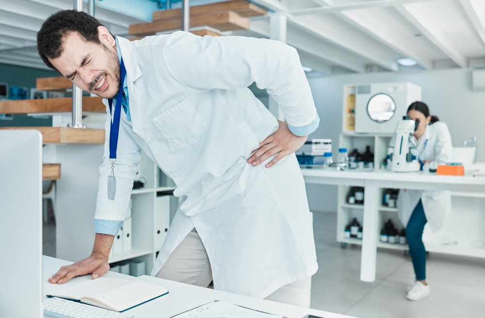 Lab worker with repetitive strain injuries and back pain