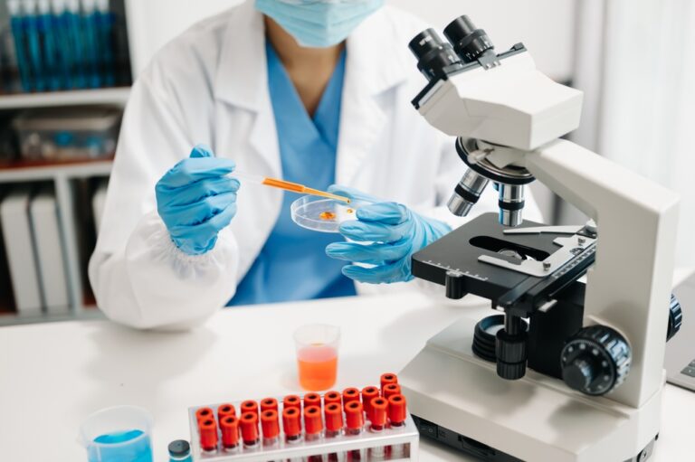 Height-adjustable lab benches - scientist mixing chemical liquids